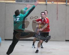 Handball - MTV Ingolstadt - Pfaffenhofen - Nico Reinecke wirft dem Pfaffenhofener Torwart Thomas Hartmair den Ball durch die Arma