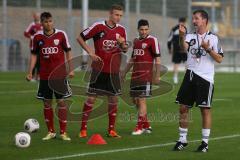 2. BL - FC Ingolstadt 04 - Saison 2013/2014 - Trainingsauftakt - Cheftrainer Marco Kurz gibt Anweisungen bei vollem Regen