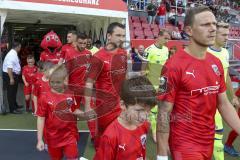 Im Bild: Peter Kurzweg (#16 FCI) läuft mit einem Kind ins Stadion

Fussball - 3. Bundesliga - Ingolstadt - Saison 2019/2020 - FC Ingolstadt 04 - MSV Duisburg - 27.07.2019 -  Foto: Ralf Lüger/rsp-sport.de