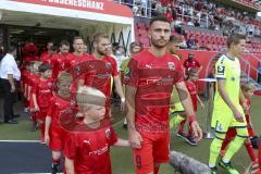 Im Bild: Fatih Kaya (#9 FCI) läuft mit einem Kind ins Stadion

Fussball - 3. Bundesliga - Ingolstadt - Saison 2019/2020 - FC Ingolstadt 04 - MSV Duisburg - 27.07.2019 -  Foto: Ralf Lüger/rsp-sport.de