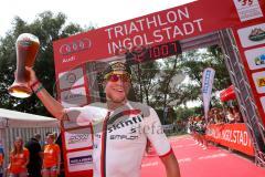 Triathlon Ingolstadt 2015 - Baggersee - Olympische Distanz, Ziel Einlauf, Emotion, Sieger Per Bittner (Leipzig) Jubel, Organisator überreicht das Bierglas